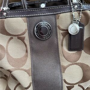 Coach Tan and Brown Signature Tote with center kiss lock.